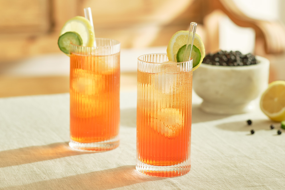 gin bottle on table with cocktails